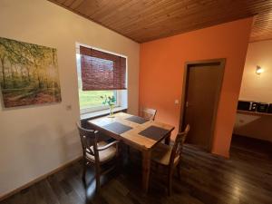 una sala da pranzo con tavolo e sedie in legno di Apartments Am Kirchkogel "Ländliche Entspannung im Herzen der Steiermark" a Pernegg an der Mur