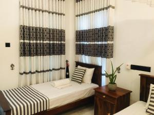 Letto o letti in una camera di Dimuthu Green Villa