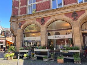 a store front of a flower shop with potted plants at Woods House in La Calamine