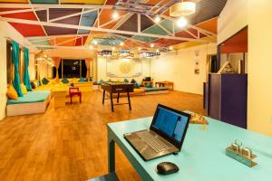 a room with a laptop on a desk in a room at Downtown Hostel Leh in Leh