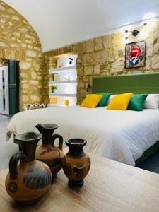 two vases sitting on a table in a bedroom at Casa Soderini in Tarquinia