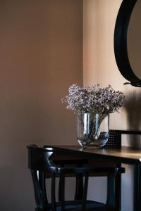 a vase of flowers sitting on top of a table at Casa do Juncal in Guimarães