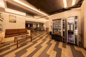 a lobby with a couch and a vending machine at Hotel Bilbi in Bilbao