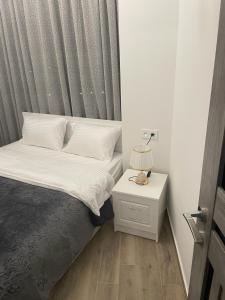 a small bedroom with a bed and a night stand at Apartment in centre of Yerevan in Yerevan