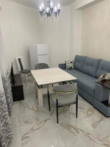 a living room with a blue couch and a table at Apartment in centre of Yerevan in Yerevan