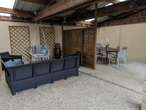 a living room with a table and chairs in it at Au coeur de nos campagnes in Lachapelle-Saint-Pierre