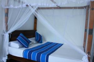 Postel nebo postele na pokoji v ubytování Mama's Hotel Weligama