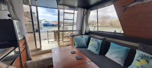 a living room with a couch and a large window at BATEAU à Quai in Avignon