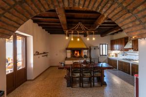 a large kitchen with a table and a stove at Il casale del Mignone in Blera +16 photos