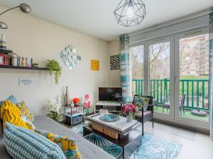 a living room with a couch and a table at Bel Apt Moderne, 1 Chambre, Balcon, Ascenseur, Parking, Proche Commerces, 10 min Plages - FR-1-3-521 in Anglet