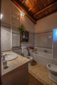 a bathroom with a sink and a toilet and a tub at Il casale del Mignone in Blera