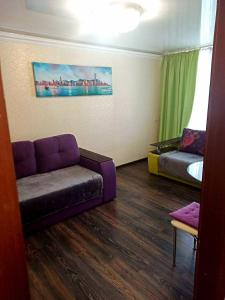 a living room with a couch and a bed at Apartments in the Center of the city in Dnipro
