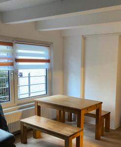 a room with a table and benches and a window at Haus Heiken in Altenburg