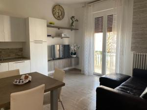 a kitchen and living room with a table and a couch at SWEET HOME in Modena