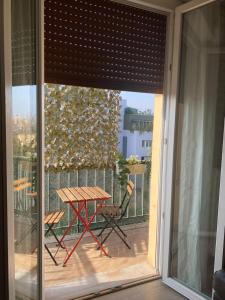 a sliding glass door with a table on a balcony at SWEET HOME in Modena