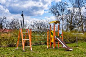 a playground with a slide and a ladder at Stanica Żeglarska Otago in Pisz