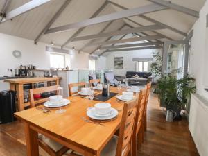 a dining room with a wooden table and chairs at An Skyber in Penzance