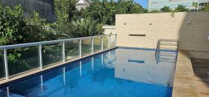 a swimming pool with a chair next to a building at Option Full Service Residence in Rio de Janeiro