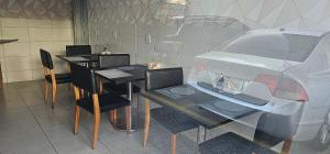 a restaurant with a table and chairs and a car at Option Full Service Residence in Rio de Janeiro