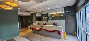 a person sitting at a counter in a office at Option Full Service Residence in Rio de Janeiro
