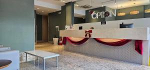 a reception desk with a red curtain in a room at Option Full Service Residence in Rio de Janeiro