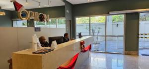 two men sitting at a desk in an office at Option Full Service Residence in Rio de Janeiro