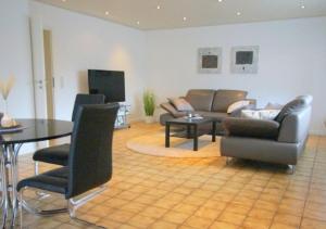 a living room with a couch and a table and chairs at Best in Town in Walldorf