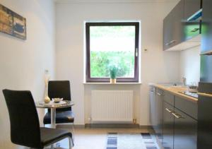 a kitchen with a table and chairs and a window at Best in Town in Walldorf