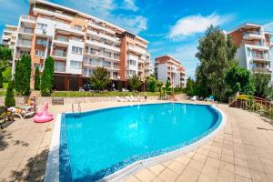 a swimming pool in front of some apartment buildings at Imperial Fort Club in Sveti Vlas