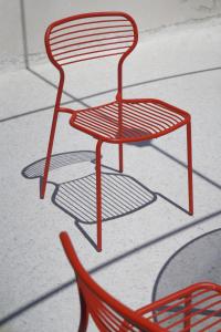 a red chair sitting on top of a floor at Family apartment with Terrace in Venice