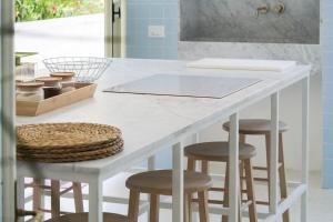 a kitchen with a white counter with stools at Family apartment with Terrace Venice Historical Center in Venice