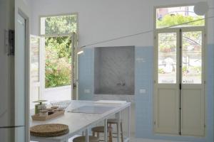 a kitchen with a white counter and two windows at Family apartment with Terrace in Venice