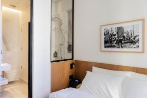 1 dormitorio con 1 cama y una foto en la pared en Zita Beirut, en Beirut