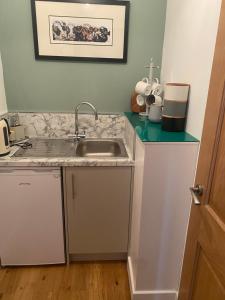 a kitchen with a sink and a counter top at Highmains in Dumfries