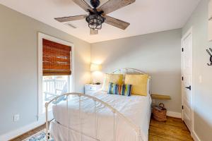 a bedroom with a bed and a ceiling fan at Salty Dawgs Jr in Mexico Beach