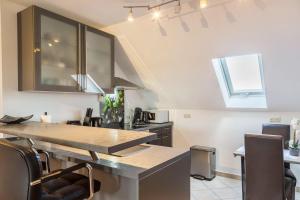 a kitchen with a counter top and some chairs at Lampl Haus 