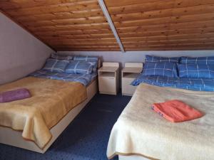 a room with two beds with blue pillows at George&Marry Guest House and hostels in Chişinău