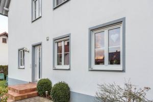 a white house with windows and a patio at Lampl Haus 