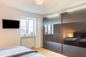 a bedroom with a bed and a flat screen tv at Lampl Haus 