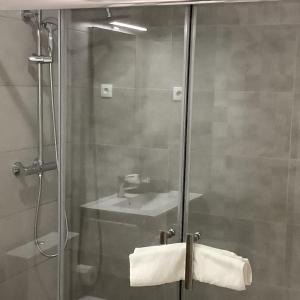 bagno con doccia, lavandino e specchio di Casa da Moagem a Vinhais