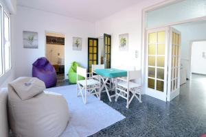 a white living room with a table and chairs at Can Baldoyra de Figueres in Figueres