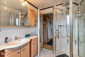 a bathroom with a sink and a shower at Ferienhaus Nahe Ostsee in Rövershagen +32 photos