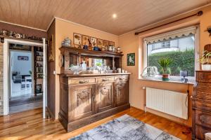 a kitchen with a large wooden cabinet and a window at Ferienhaus Nahe Ostsee in Rövershagen