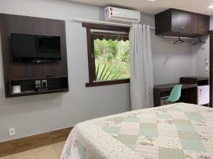 TV a/nebo společenská místnost v ubytování Canto de Roca Turismo e Lazer