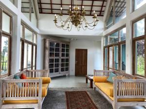 a living room with a couch and a chandelier at Wild Ele 243 Wilpattu in Achchamulai