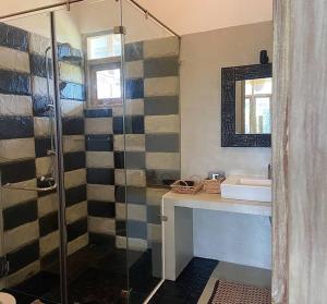 a bathroom with a shower and a sink at Wild Ele 243 Wilpattu in Achchamulai
