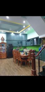 a kitchen with a table and chairs in a room at Romantic house with garden in Bien Hoa in Bùi Tiếng