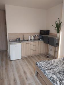 a kitchen with a sink and a desk in a room at Studio near Old Town in Krakow