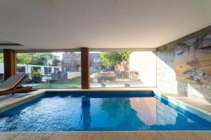 una piscina en una casa con una ventana grande en APART HOTEL SPA BUENOS AIRES EZEIZA DEP 2 A 20 minutos de aeropuerto ministro pistarini ezeiza en Ezeiza