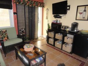 a living room with a couch and a tv at Vintage Merlot Bed and Breakfast in Oliver